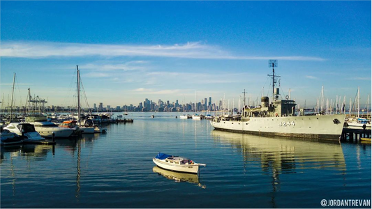 With a backdrop of blue skies, anchored ships in the foreground, and a bustling cityscape in the distance, this view is truly awe-inspiring.